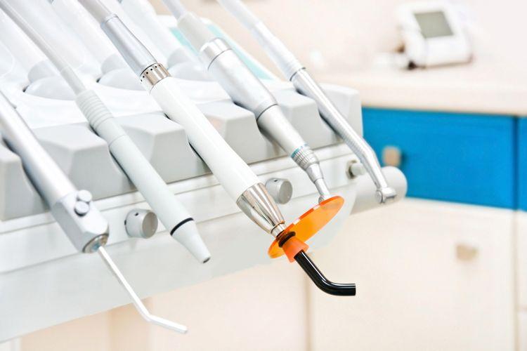 Dental handpieces and a curing light on a dental unit