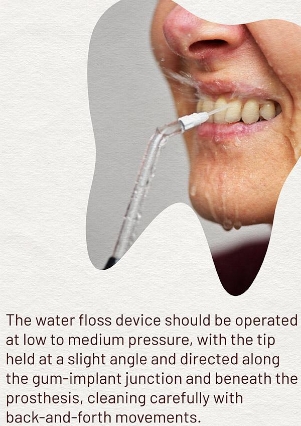 Person using a water flosser on the teeth