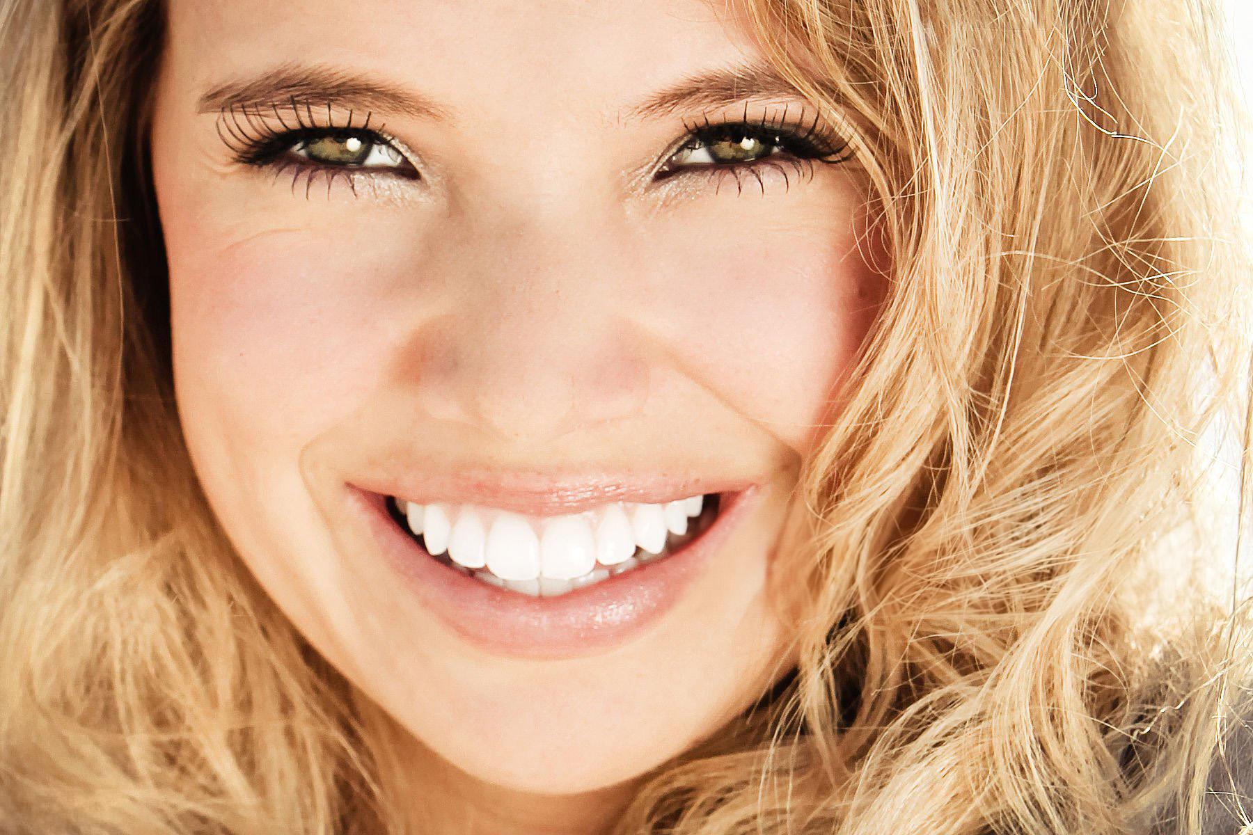 Close-up of a smiling woman with white teeth