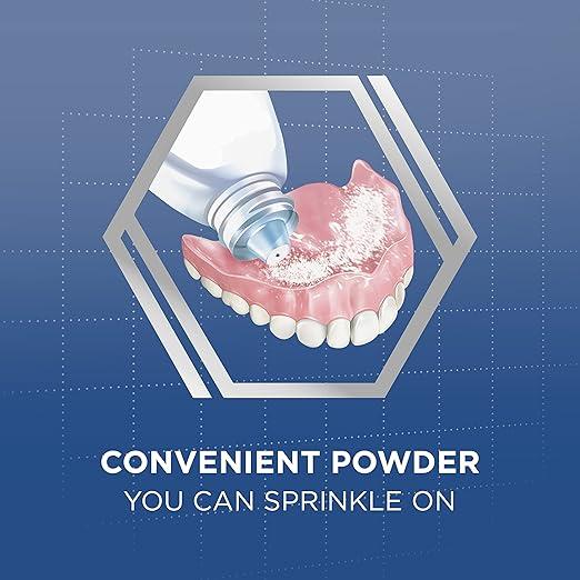 Denture with adhesive powder being sprinkled from a tube