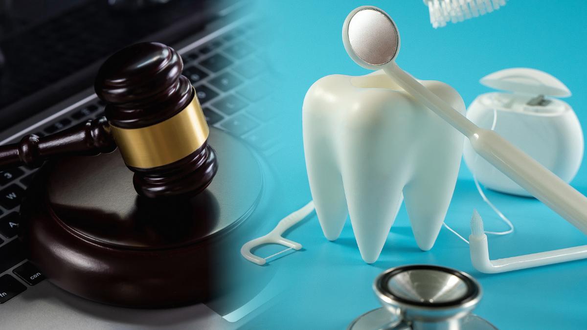 Judge's gavel next to a tooth model, dental mirror and floss