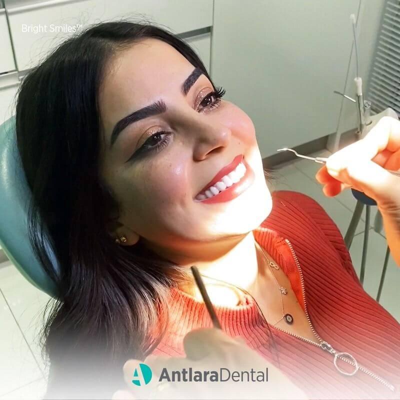 Smiling patient in a dental chair during an examination
