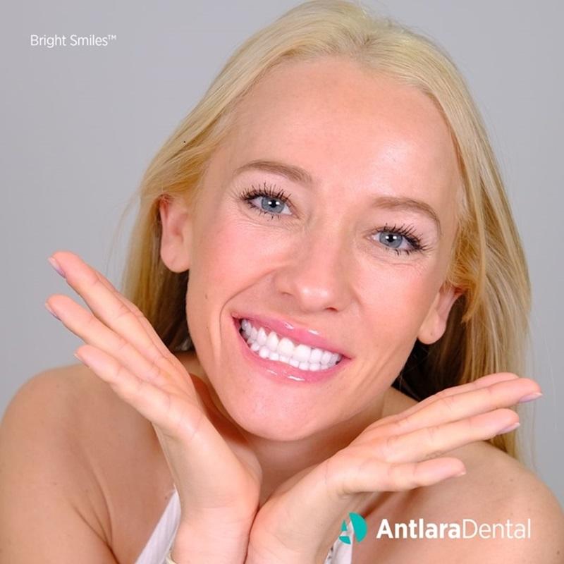 Smiling woman showing her front teeth