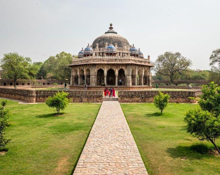 Domed historic building with a stone path and gardens