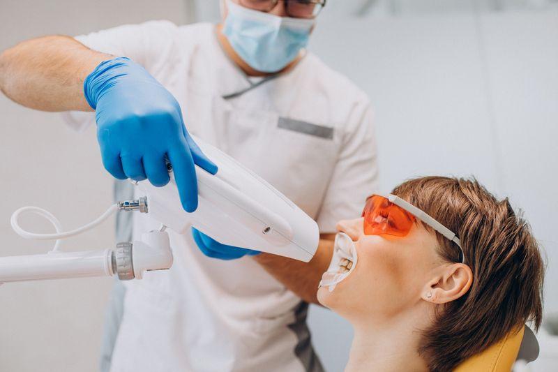 Patient and dentist during a teeth whitening treatment