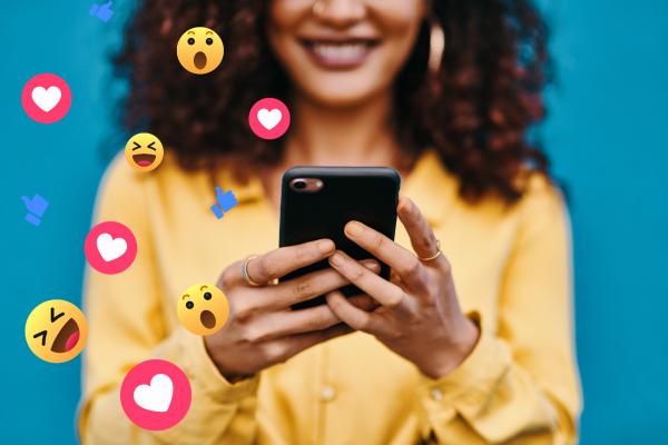 Person holding a phone surrounded by reaction emojis