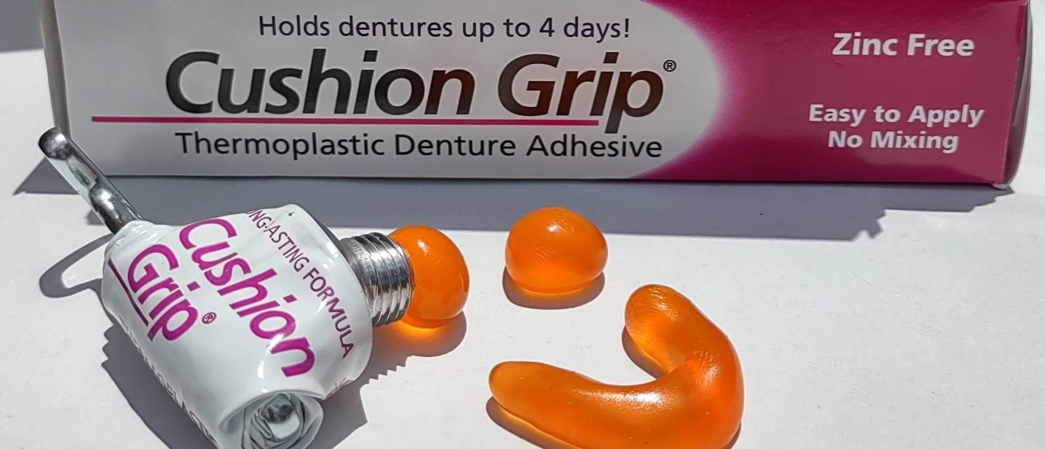 Boxed thermoplastic denture adhesive with orange adhesive samples