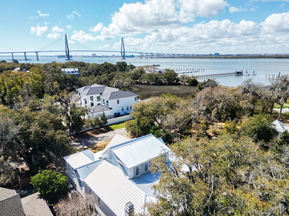 Aerial view of luxury coastal homes in Mount Pleasant, South Carolina, with the Arthur Ravenel Jr. Bridge spanning the water in the background