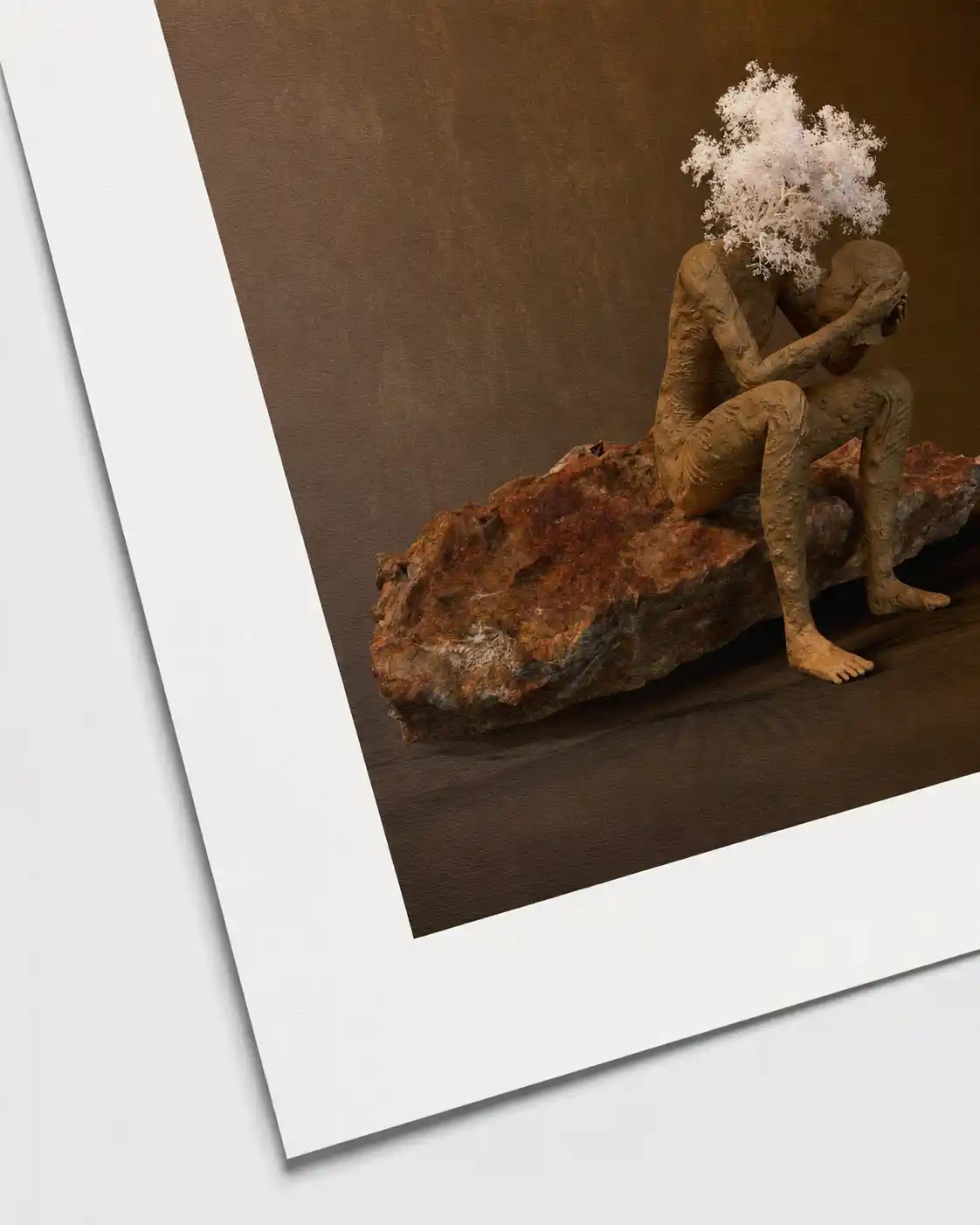 Digital sculpture of a seated figure on a rock holding its own head, with white tree branches rising above.