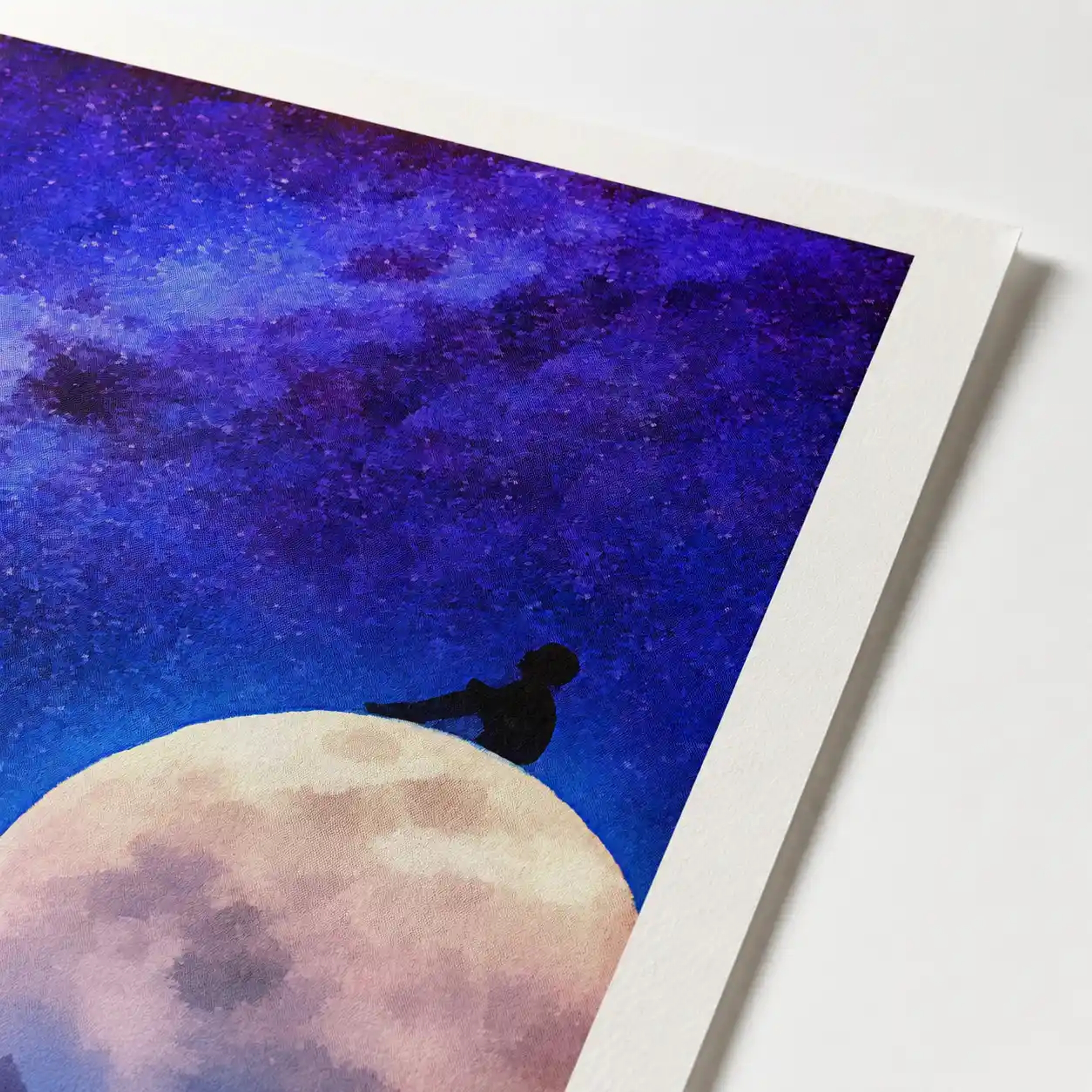 Silhouette of a person sitting on a huge glowing full moon under a textured purple and blue starry night sky with a shooting star.
