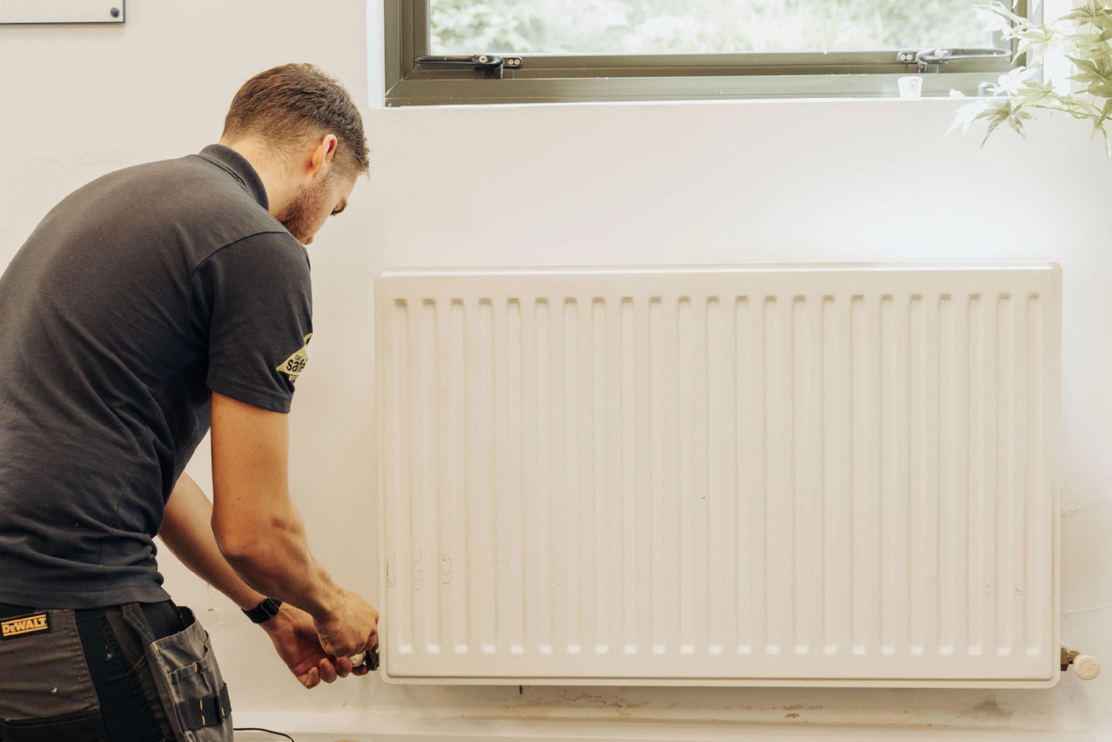 Modern central heating radiator with thermostatic valve installed
