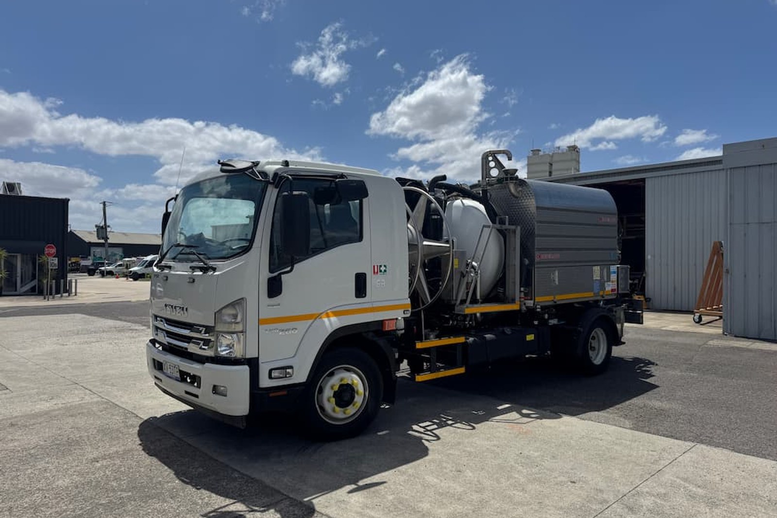 Vacuum truck cleaning sewer manholes