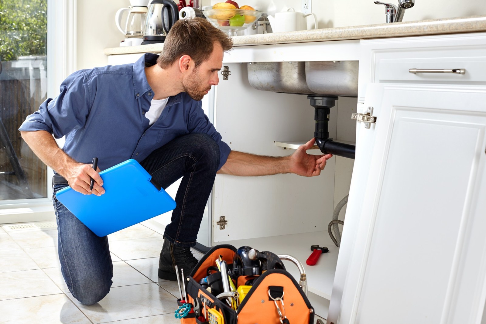 Plumber working at a client home in Tallinn Estonia