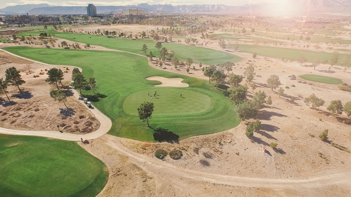 Aerial view of a pristine golf course green and fairway
