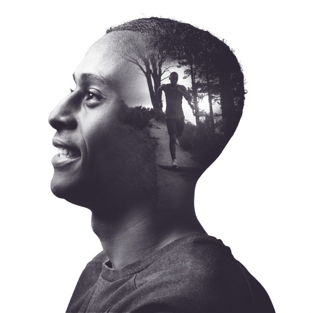 Double-exposure portrait of a man in profile, with a runner on a forest trail inside his silhouette