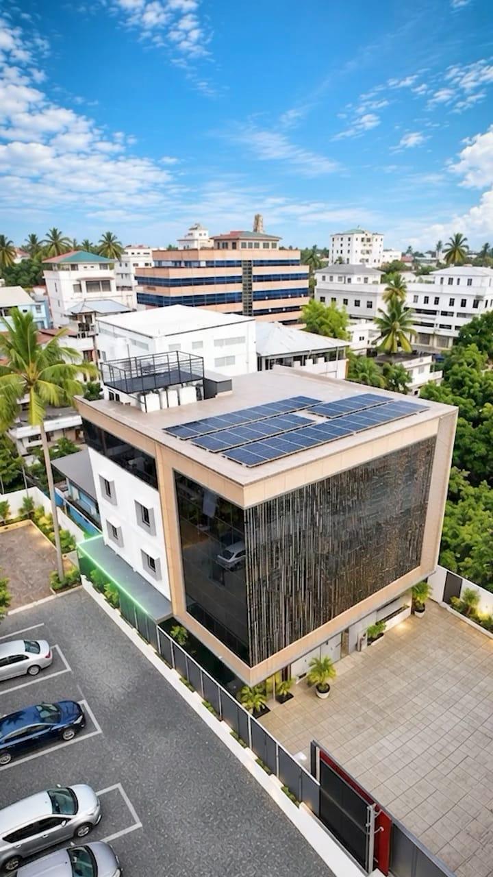 Aerial view of G K Tower with its solar roof, glass facade and car park