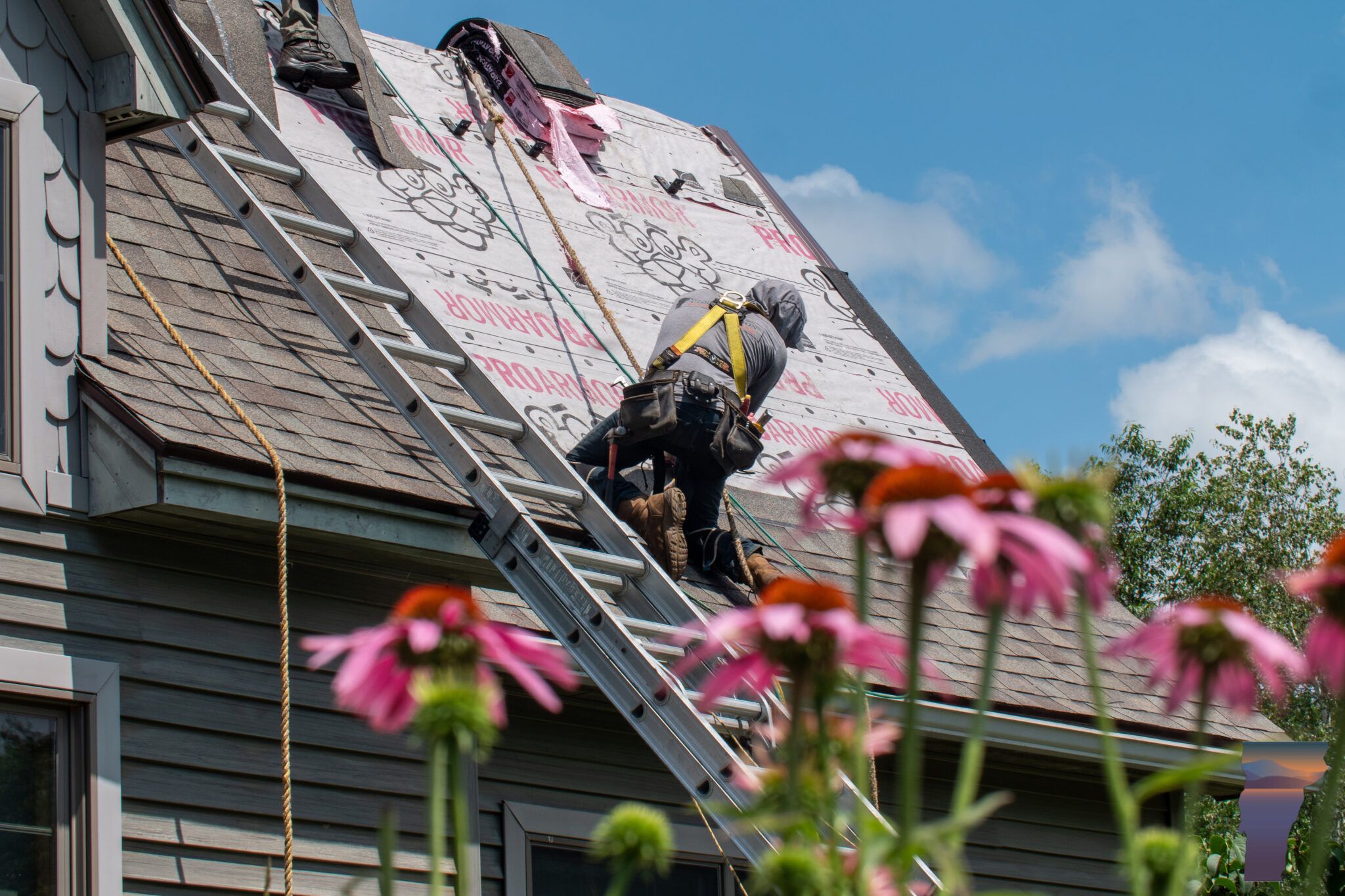 team working on roof with ladder