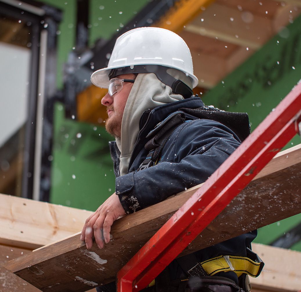 worker carrying wood