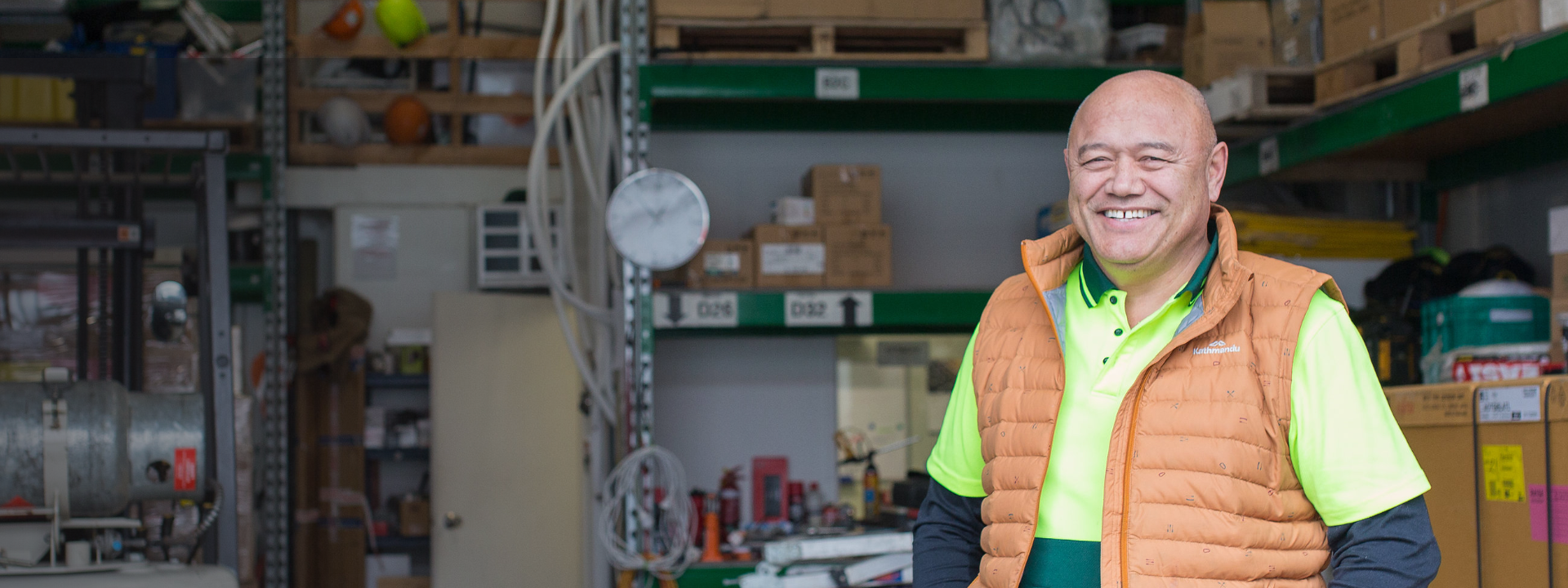 Man standing in orange vest