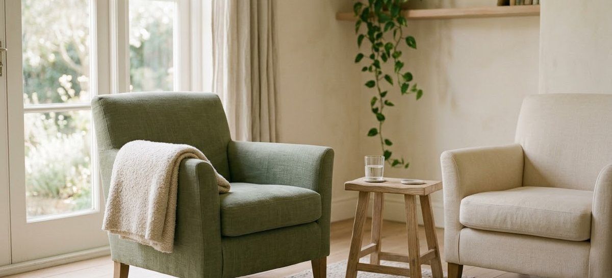 Two armchairs turned toward each other beside a window, with a small side table between them