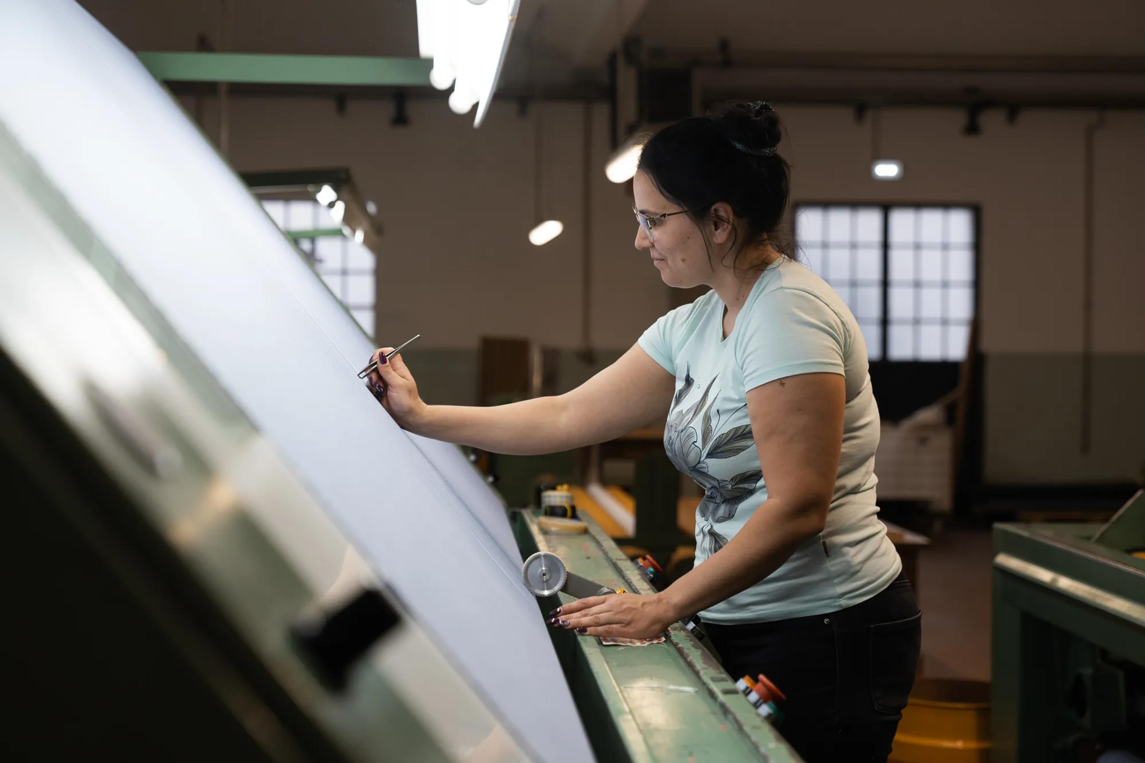 A RIFER specialist sewing on the production floor