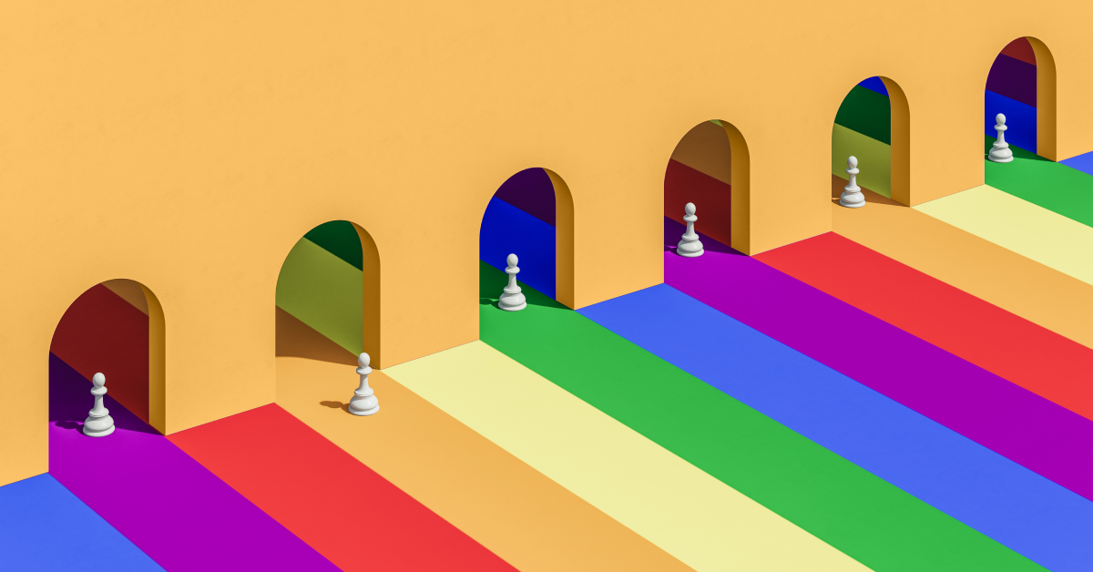 Chess pawns on a rainbow colored floor. 