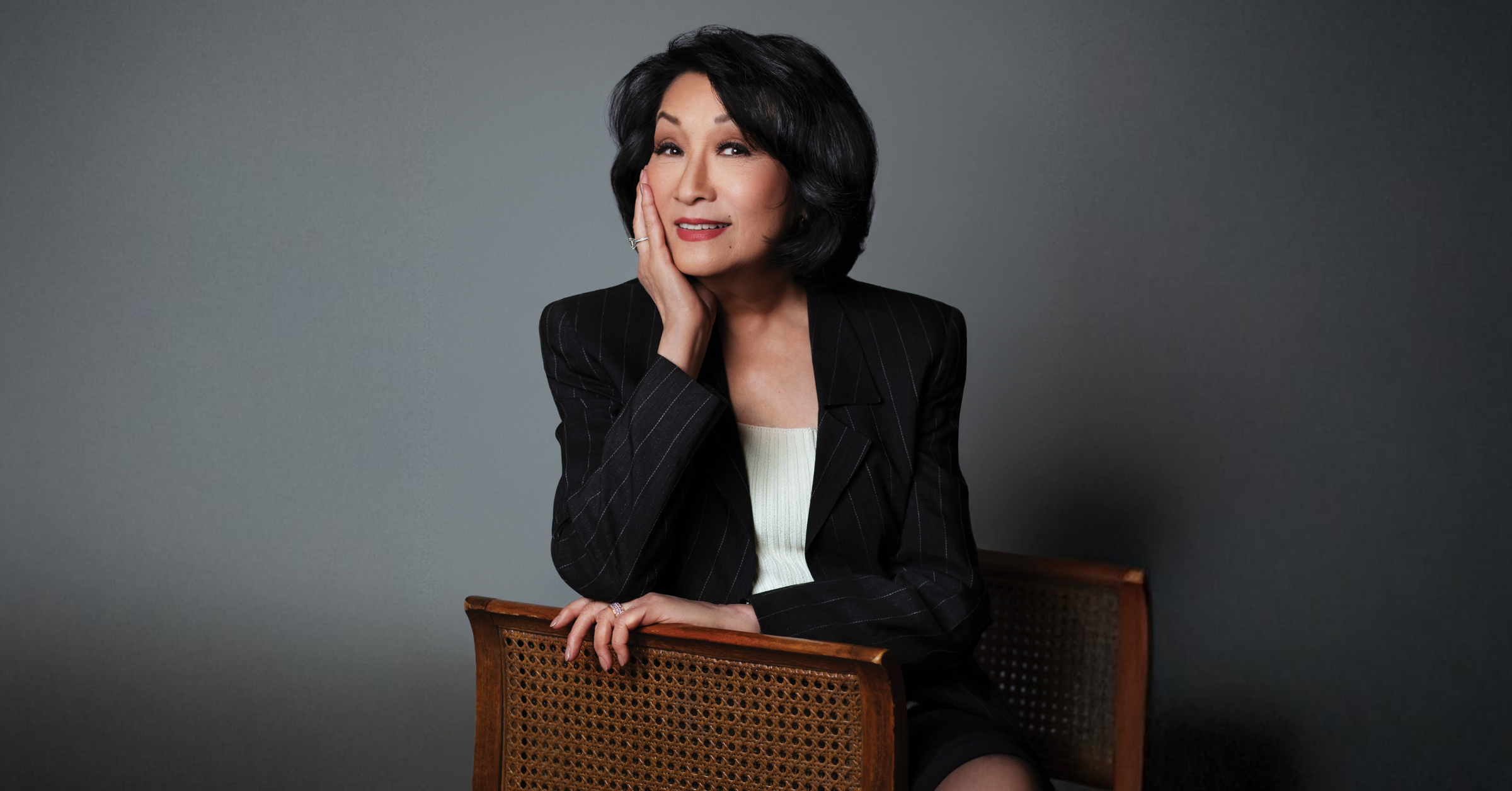 A headshot of Connie Chung wearing a black blazer. 