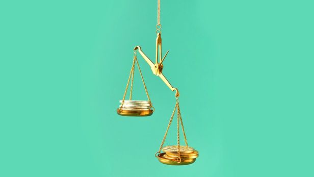 Scale with coins representing balance of full-time and fractional work