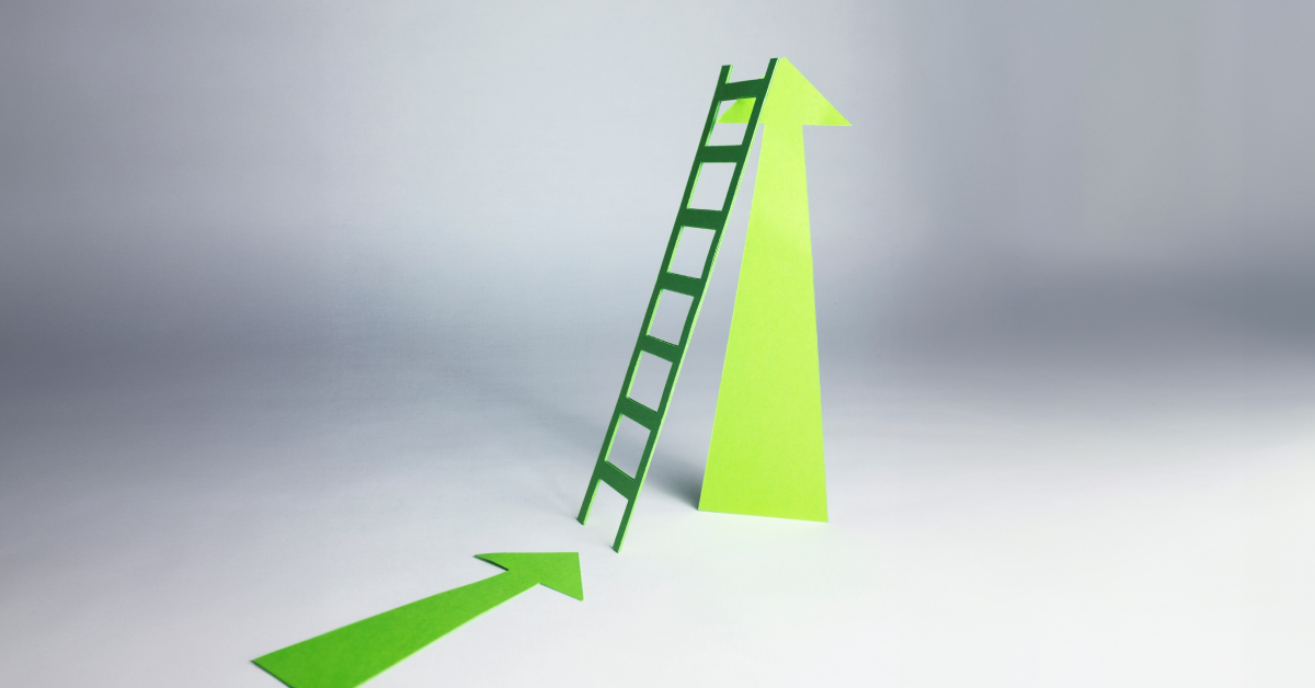 A green ladder with an up green arrow behind it. 