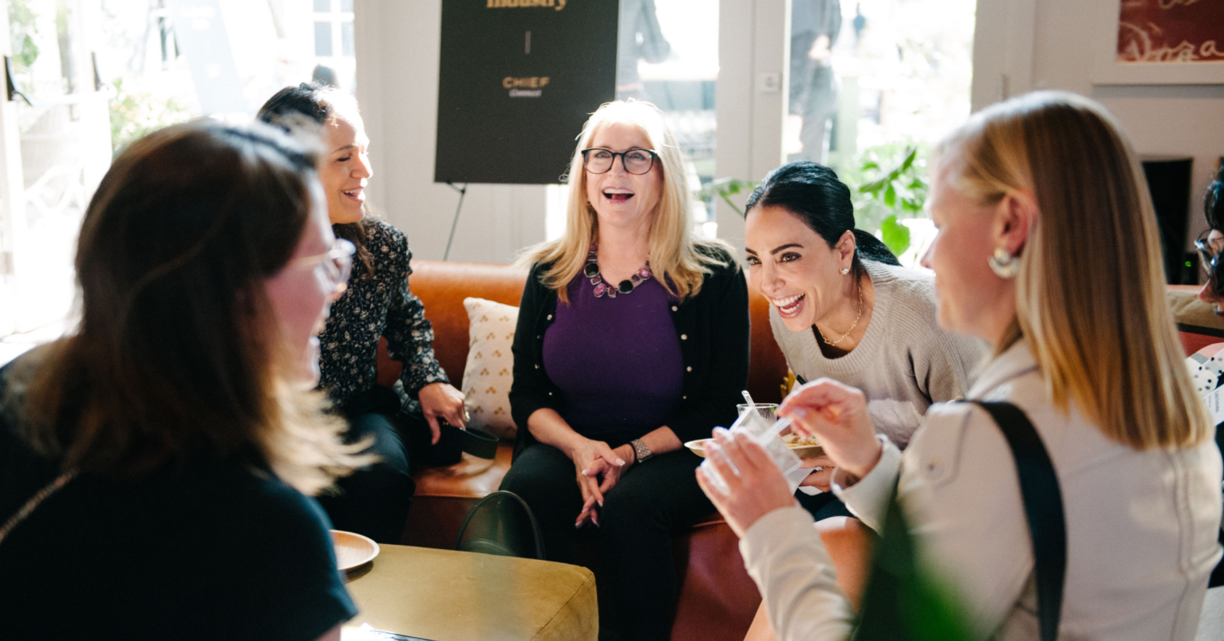 Members seated in a circle in conversation