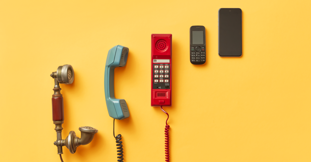Five different telephones, from old to new styles, on a yellow background. 