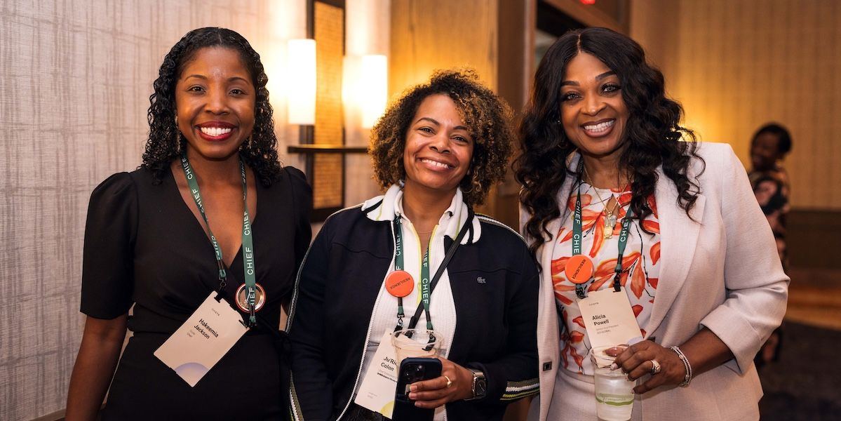 Three Chief Members smiling while posing for a picture at ChiefX Atlanta