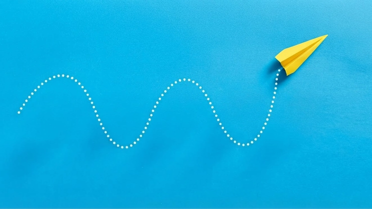 Illustration of paper airplane following curving path