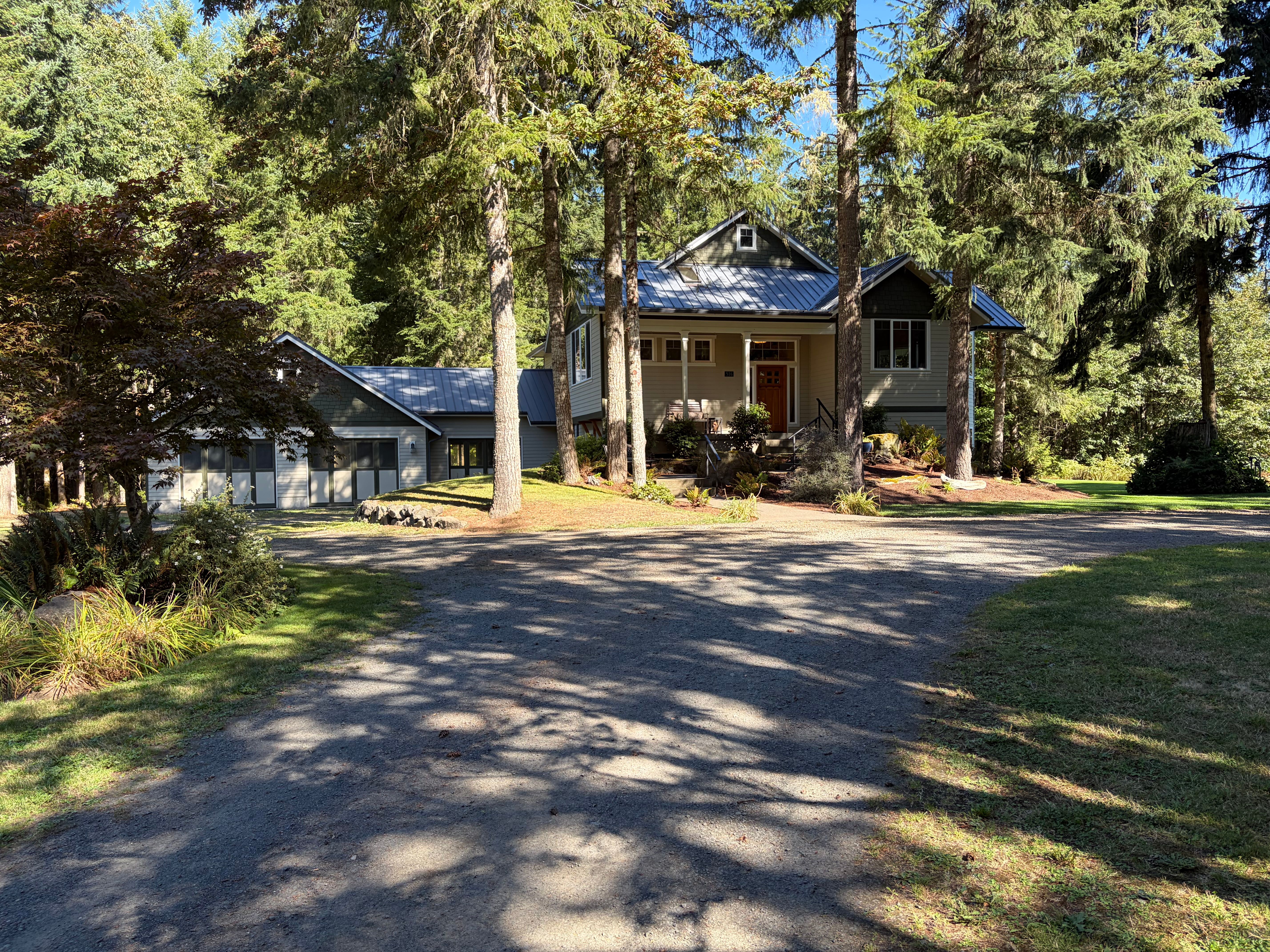 Blue Mountain Retreat from the lawn — deck, jacuzzi, and the woods