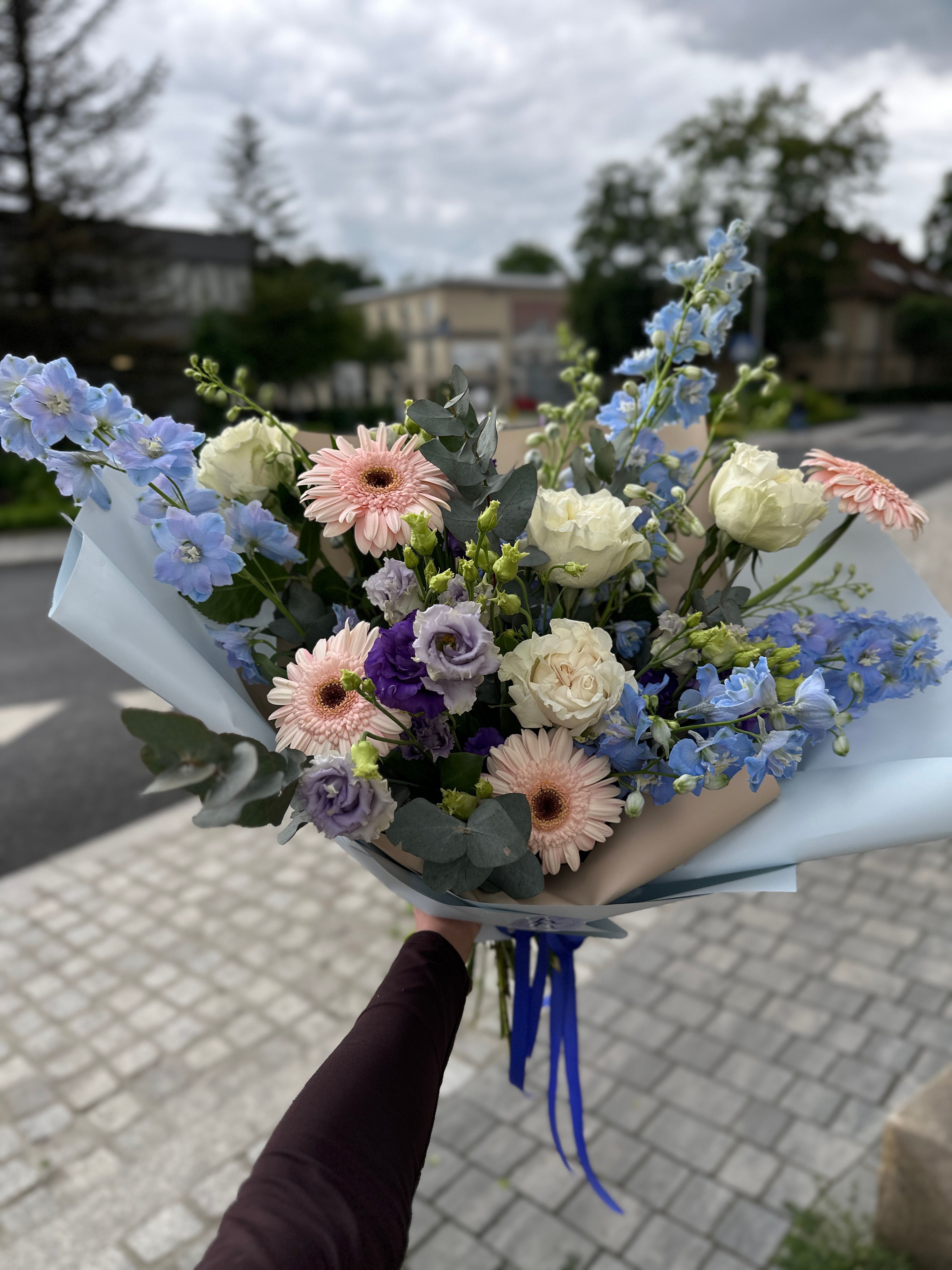 Bukiet pastelowy z błękitem wykonany ostróżki, gerber, róż i eukaliptusa