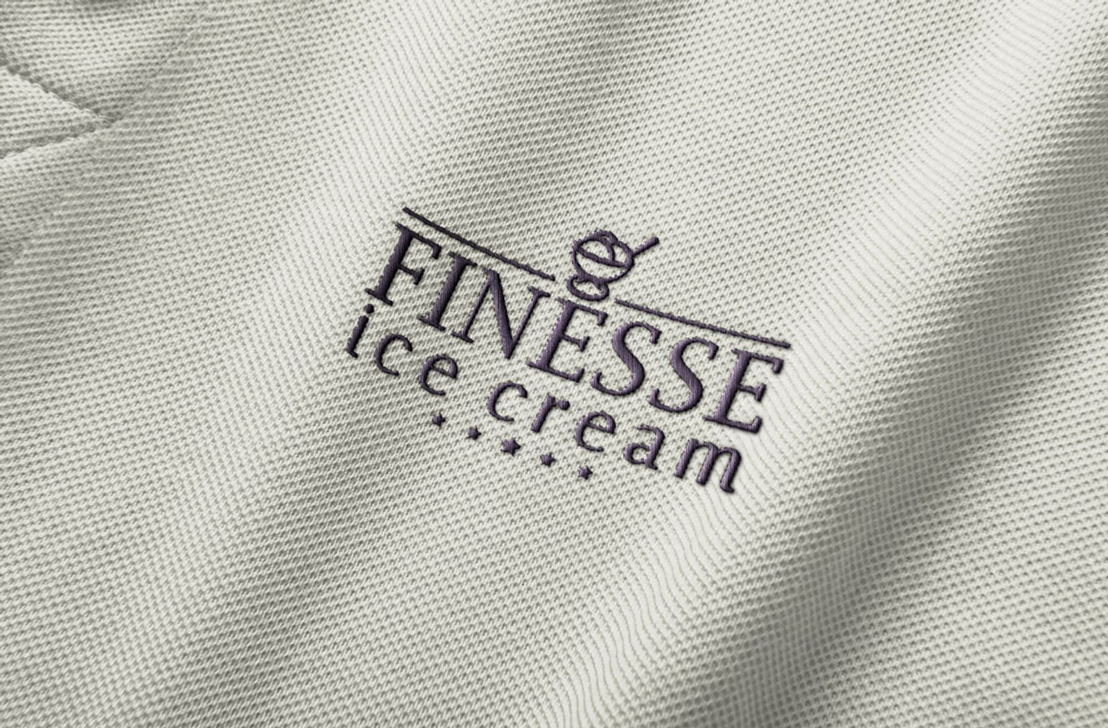 The Finesse mark embroidered into a staff polo shirt