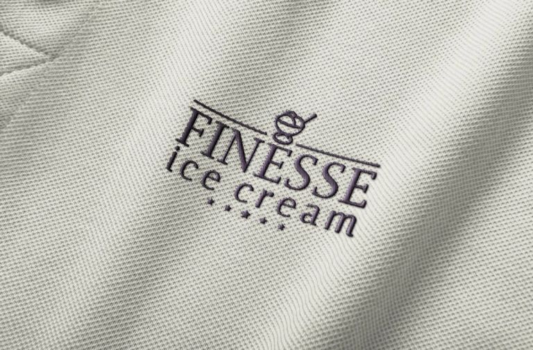 The Finesse mark embroidered into a staff polo shirt