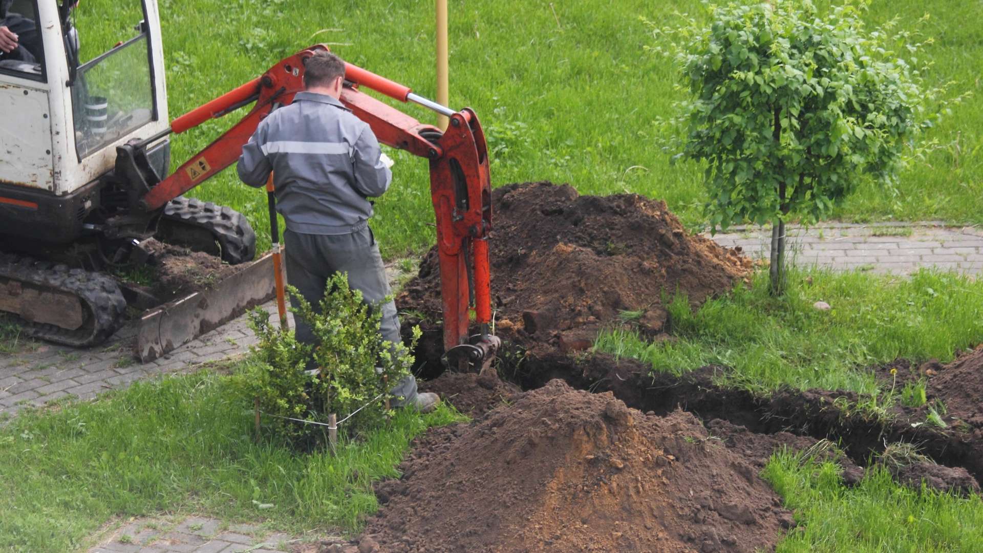 Pieni kaivinkone kaivamassa maata