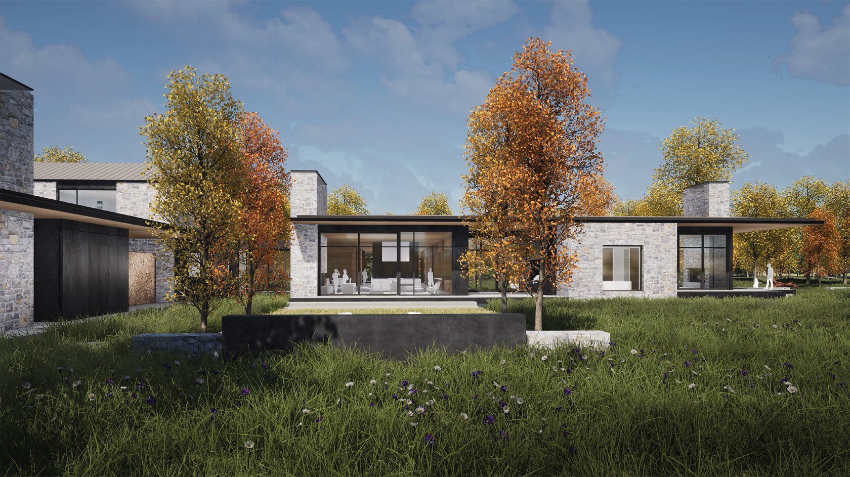 Contemporary stone and glass house with large windows, featuring flat roof lines and a stone facade. The modern residence is set in a grassy field with wildflowers, framed by vibrant yellow and orange autumn trees, with minimalist figures visible inside and on an outdoor patio.