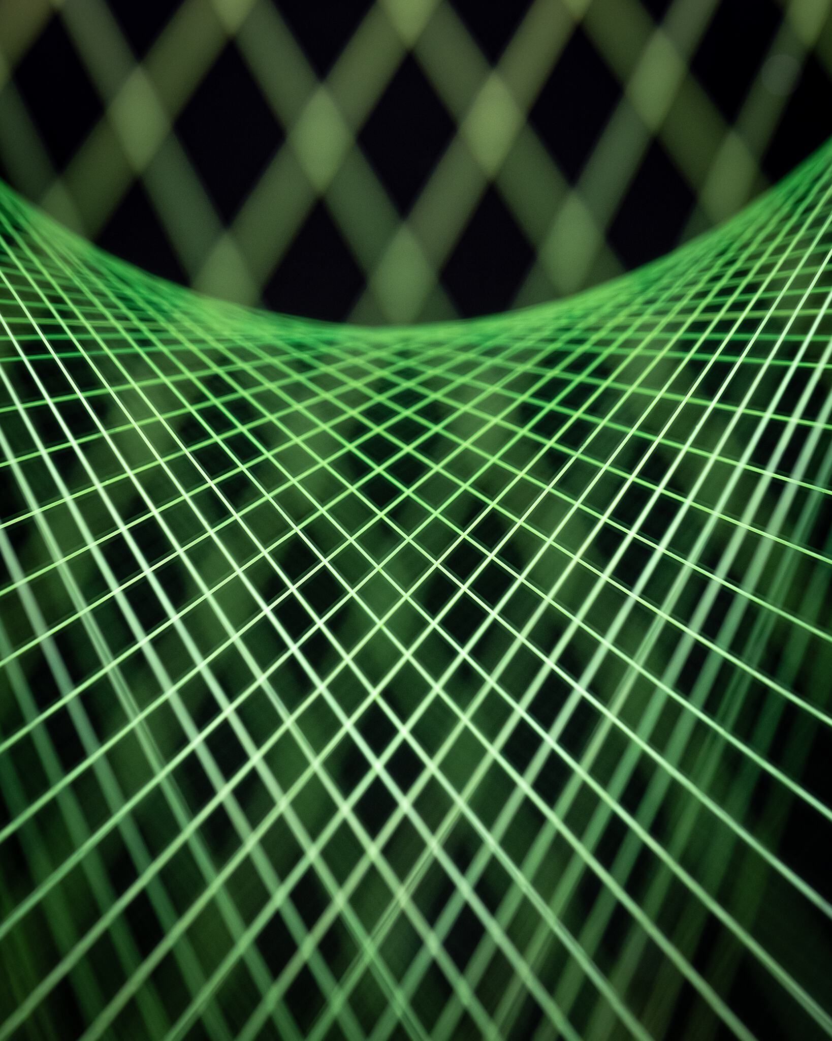 A vibrant green geometric grid curves across the image, sharply focused in the foreground and blurring into a dark background with larger, out-of-focus diamond patterns.