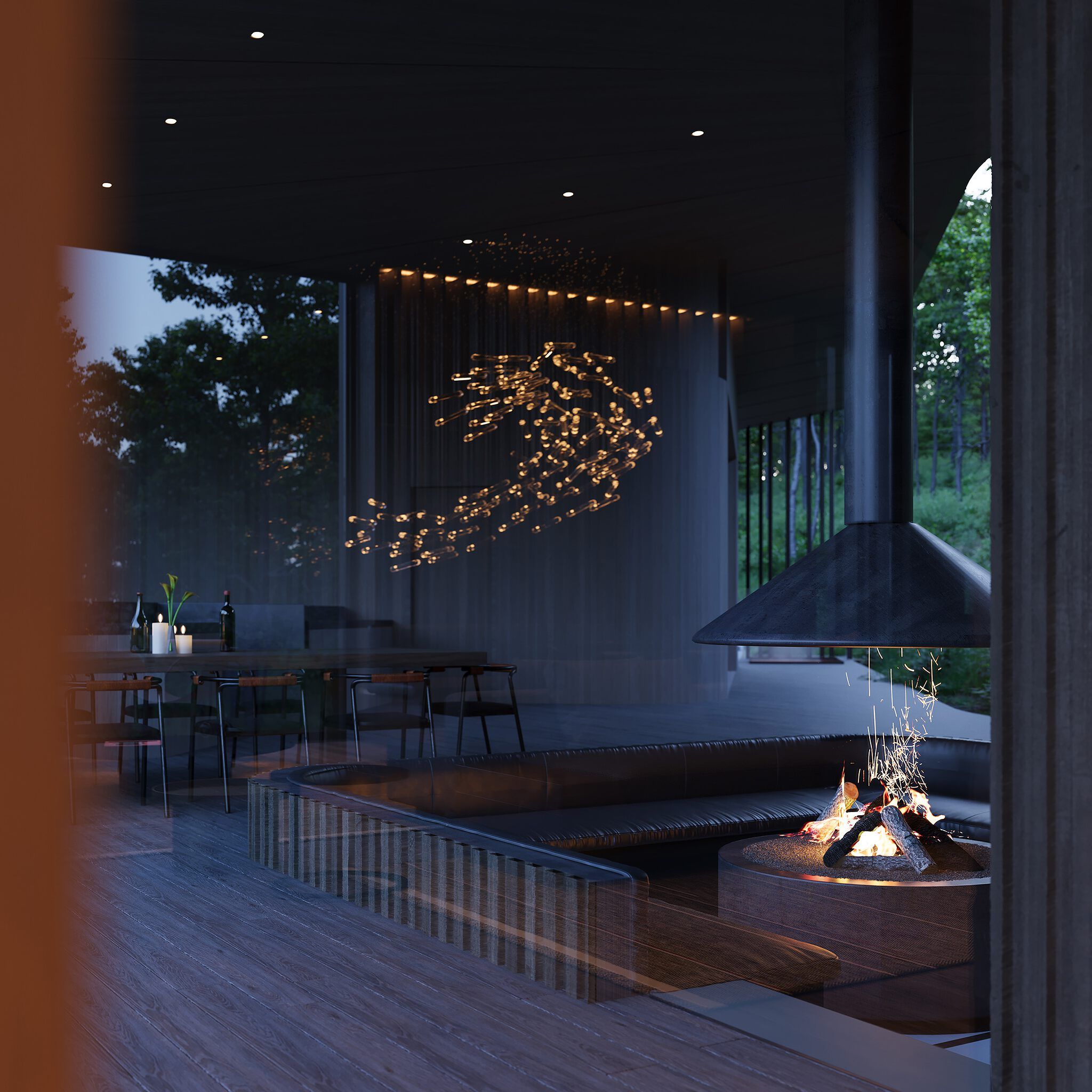 Modern luxury living space featuring a central fire pit with sparks and a dark curved seating area, illuminated by an artistic wave-like chandelier. A sleek dining table with candles and wine bottles is visible, with expansive windows overlooking a dark forest at night.