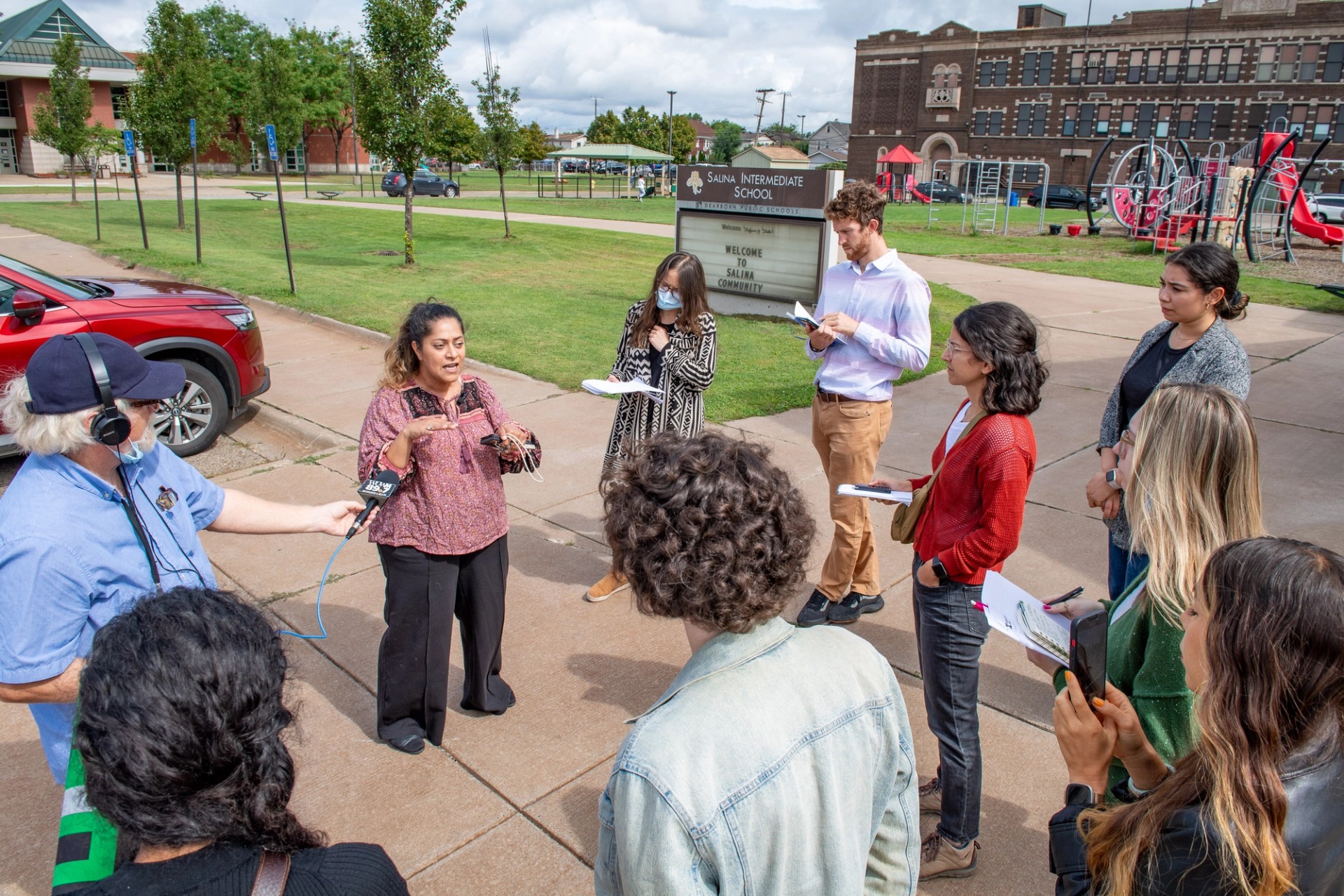 Samra’a Luqman speaking to a crowd of reporters during the tour