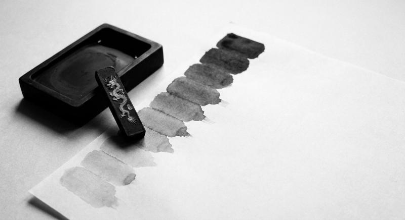 Ink stone and ink stick beside stepped gray ink gradient swatches