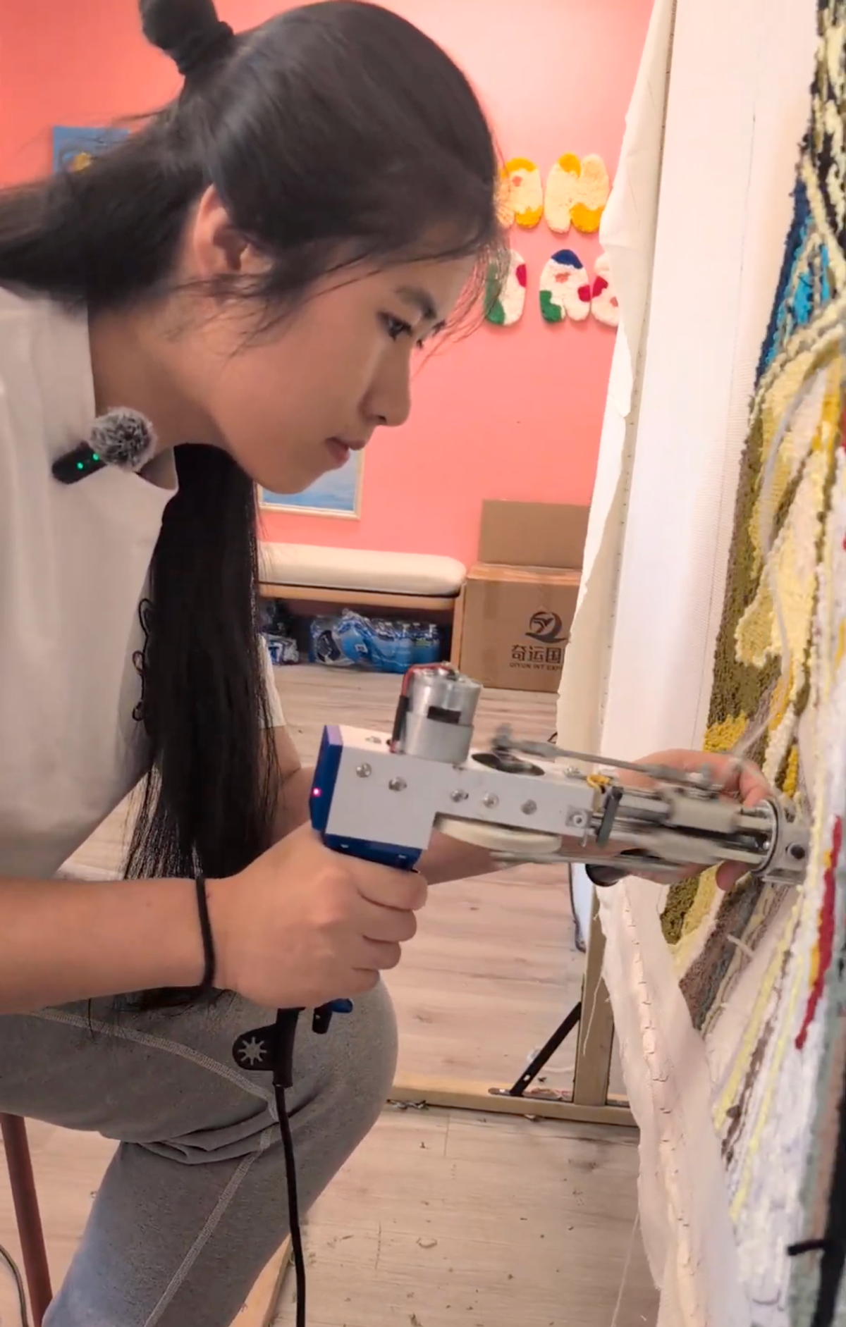 Michelle tufting an art piece for a local restaurant opening
