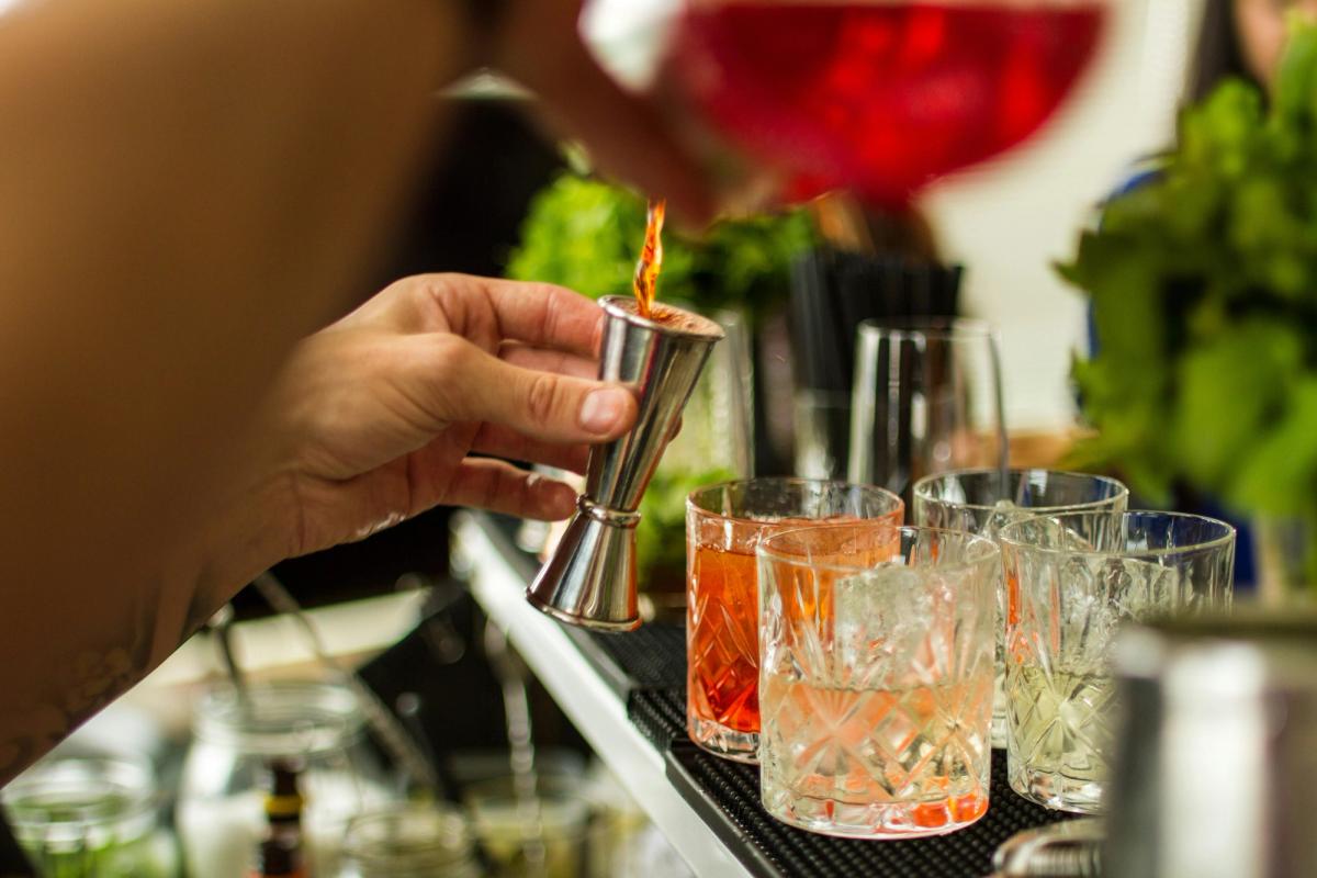 Someone mixing a drink at a bar