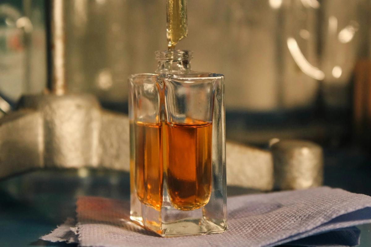 A perfume bottle being filled