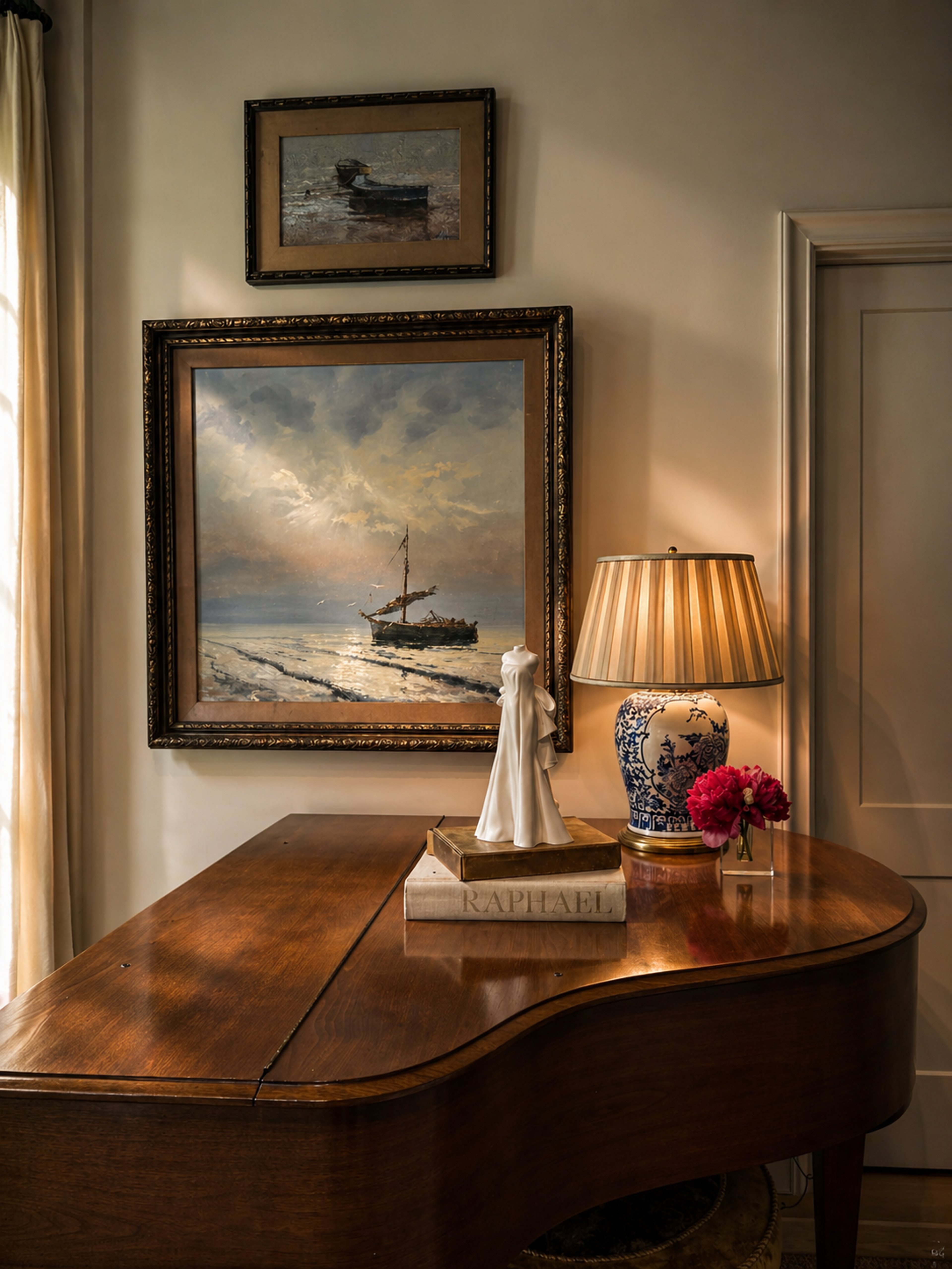 White wedding gown sculpture displayed on a wooden grand piano beside a table lamp and framed paintings.