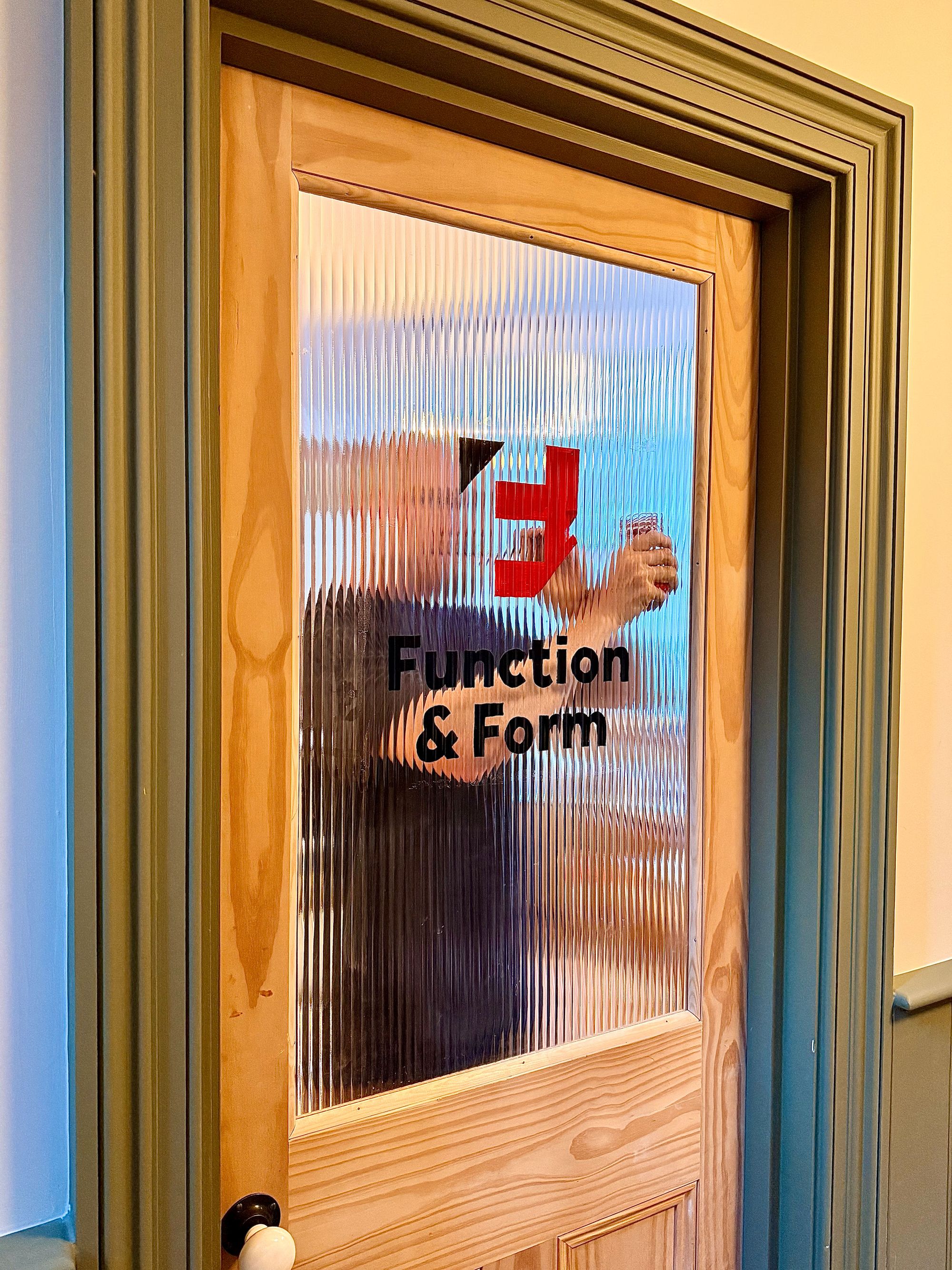 Me painting the Function & Form logo on the office door