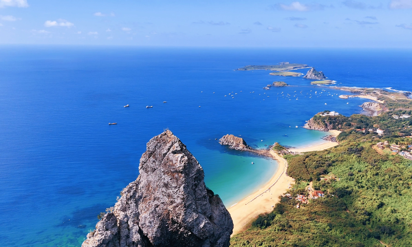 Aerial view of Morro Dois Irmãos and Baía dos Porcos in Fernando de Noronha, one of the island's most popular excursions.