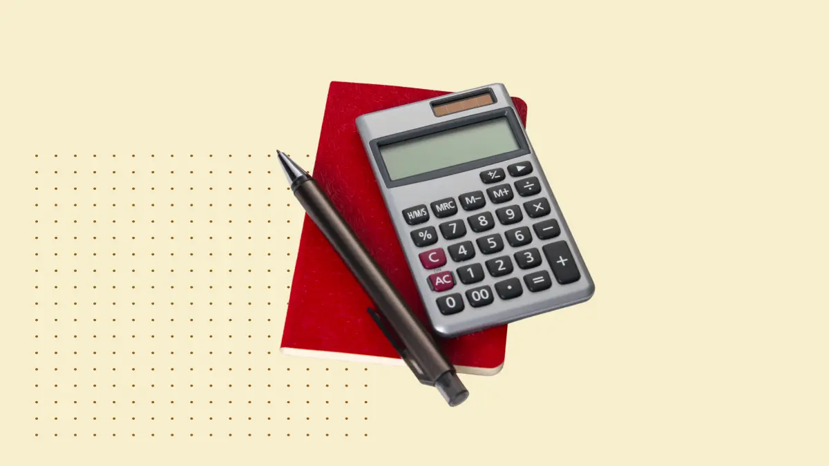 calculator with pen on red sticky note